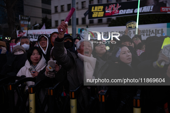 Citizens cheer after the impeachment of President Yoon Suk-yeol is passed in Seoul, South Korea, on December 14, 2024. Approximately 2 milli...