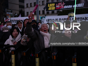 Citizens cheer after the impeachment of President Yoon Suk-yeol is passed in Seoul, South Korea, on December 14, 2024. Approximately 2 milli...