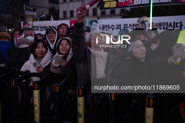 Citizens cheer after the impeachment of President Yoon Suk-yeol is passed in Seoul, South Korea, on December 14, 2024. Approximately 2 milli...