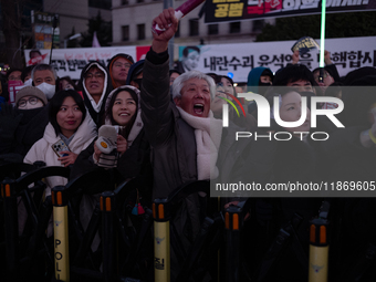 Citizens cheer after the impeachment of President Yoon Suk-yeol is passed in Seoul, South Korea, on December 14, 2024. Approximately 2 milli...