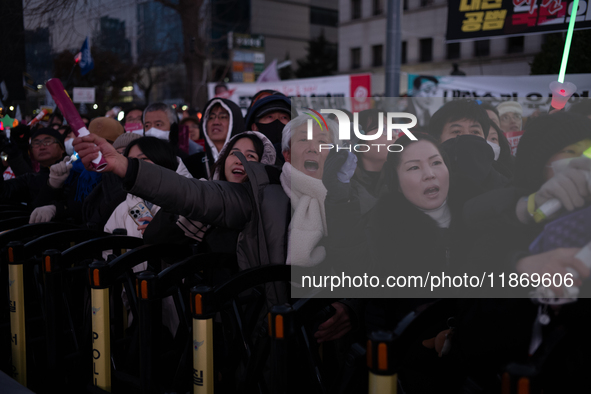 Citizens cheer after the impeachment of President Yoon Suk-yeol is passed in Seoul, South Korea, on December 14, 2024. Approximately 2 milli...