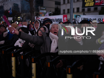 Citizens cheer after the impeachment of President Yoon Suk-yeol is passed in Seoul, South Korea, on December 14, 2024. Approximately 2 milli...