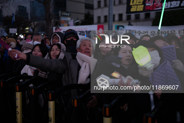 Citizens cheer after the impeachment of President Yoon Suk-yeol is passed in Seoul, South Korea, on December 14, 2024. Approximately 2 milli...