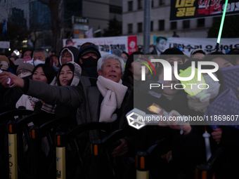 Citizens cheer after the impeachment of President Yoon Suk-yeol is passed in Seoul, South Korea, on December 14, 2024. Approximately 2 milli...