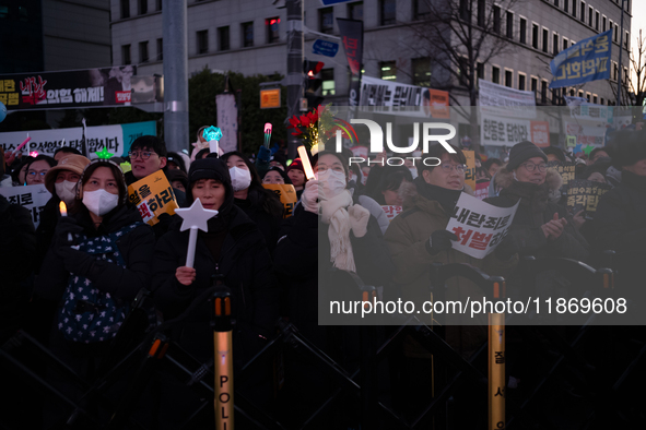 Citizens cheer after the impeachment of President Yoon Suk-yeol is passed in Seoul, South Korea, on December 14, 2024. Approximately 2 milli...