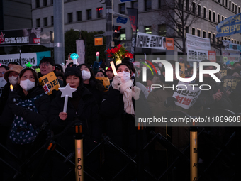 Citizens cheer after the impeachment of President Yoon Suk-yeol is passed in Seoul, South Korea, on December 14, 2024. Approximately 2 milli...