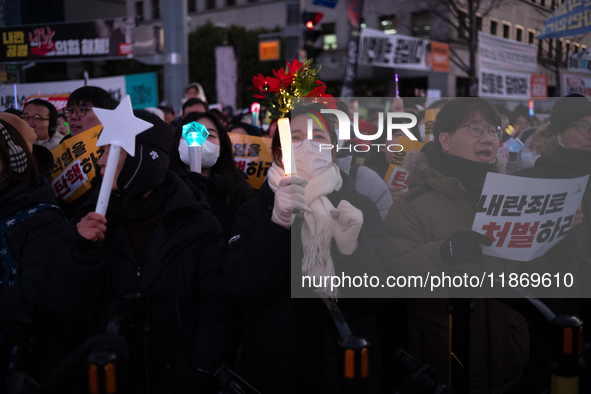 Citizens cheer after the impeachment of President Yoon Suk-yeol is passed in Seoul, South Korea, on December 14, 2024. Approximately 2 milli...