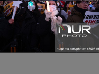 Citizens cheer after the impeachment of President Yoon Suk-yeol is passed in Seoul, South Korea, on December 14, 2024. Approximately 2 milli...