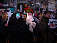 Citizens cheer after the impeachment of President Yoon Suk-yeol is passed in Seoul, South Korea, on December 14, 2024. Approximately 2 milli...