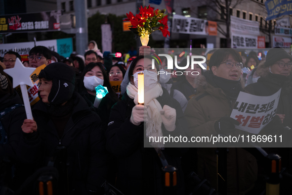 Citizens cheer after the impeachment of President Yoon Suk-yeol is passed in Seoul, South Korea, on December 14, 2024. Approximately 2 milli...