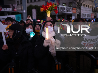 Citizens cheer after the impeachment of President Yoon Suk-yeol is passed in Seoul, South Korea, on December 14, 2024. Approximately 2 milli...