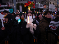 Citizens cheer after the impeachment of President Yoon Suk-yeol is passed in Seoul, South Korea, on December 14, 2024. Approximately 2 milli...