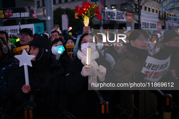 Citizens cheer after the impeachment of President Yoon Suk-yeol is passed in Seoul, South Korea, on December 14, 2024. Approximately 2 milli...