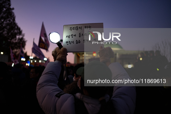 Citizens cheer after the impeachment of President Yoon Suk-yeol is passed in Seoul, South Korea, on December 14, 2024. Approximately 2 milli...