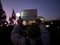 Citizens cheer after the impeachment of President Yoon Suk-yeol is passed in Seoul, South Korea, on December 14, 2024. Approximately 2 milli...