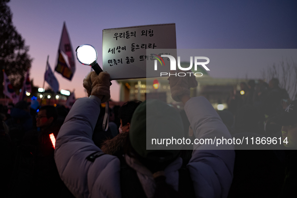 Citizens cheer after the impeachment of President Yoon Suk-yeol is passed in Seoul, South Korea, on December 14, 2024. Approximately 2 milli...