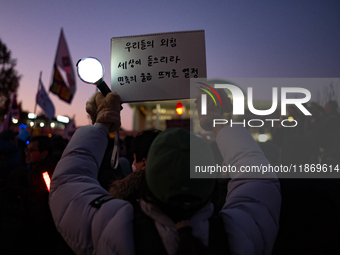 Citizens cheer after the impeachment of President Yoon Suk-yeol is passed in Seoul, South Korea, on December 14, 2024. Approximately 2 milli...