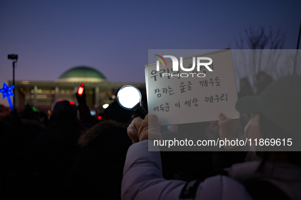 Citizens cheer after the impeachment of President Yoon Suk-yeol is passed in Seoul, South Korea, on December 14, 2024. Approximately 2 milli...