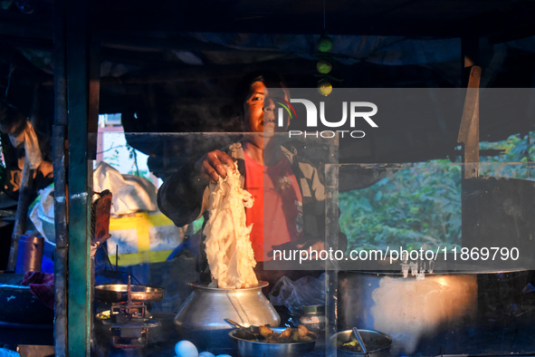 A shopkeeper prepares food for breakfast in a roadside shop in Kolkata, India, on December 15, 2024. 