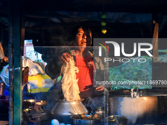 A shopkeeper prepares food for breakfast in a roadside shop in Kolkata, India, on December 15, 2024. (