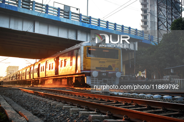 People travel on a Suburban Railway in Kolkata, India, on December 15, 2024. 