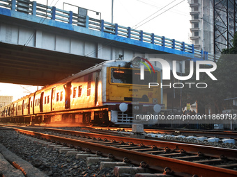 People travel on a Suburban Railway in Kolkata, India, on December 15, 2024. (