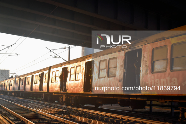 People travel on a Suburban Railway in Kolkata, India, on December 15, 2024. 