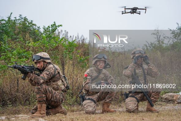 Armed police officers conduct an anti-terrorism drill using drones in Guiyang, Guizhou province, China, on December 6, 2024. 