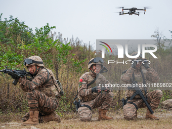 Armed police officers conduct an anti-terrorism drill using drones in Guiyang, Guizhou province, China, on December 6, 2024. (