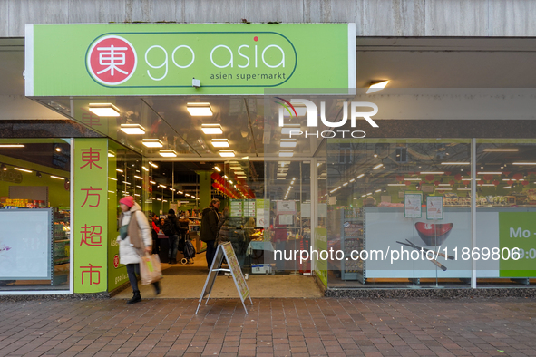 The 'Go Asia' supermarket in Augsburg, Bavaria, Germany, on December 14, 2024, stands out with its bright green signage and glass-panel entr...