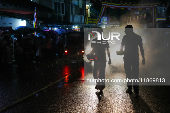 People attend a procession before the start of the Adams Peak (Sri Pada) season in Ratnapura, Sri Lanka, on December 13, 2024. The site is k...