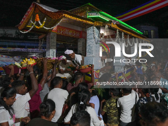 People attend a procession before the start of the Adams Peak (Sri Pada) season in Ratnapura, Sri Lanka, on December 13, 2024. The site is k...