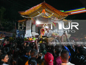 People attend a procession before the start of the Adams Peak (Sri Pada) season in Ratnapura, Sri Lanka, on December 13, 2024. The site is k...