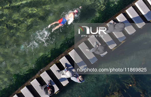 A winter swimming enthusiast takes a winter swim in the natural waters of the Heilong Cave in Handan, Hebei province, on December 15, 2024. 