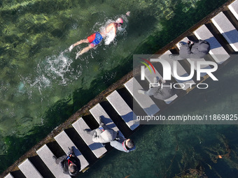 A winter swimming enthusiast takes a winter swim in the natural waters of the Heilong Cave in Handan, Hebei province, on December 15, 2024....