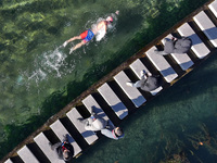 A winter swimming enthusiast takes a winter swim in the natural waters of the Heilong Cave in Handan, Hebei province, on December 15, 2024....