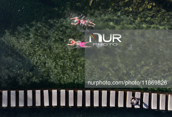 Winter swimming enthusiasts swim in the natural waters of Heilong Cave in Handan, China, on December 15, 2024. 