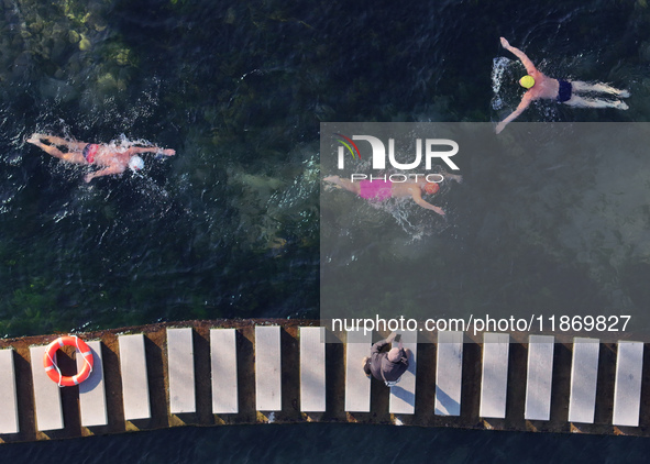 Winter swimming enthusiasts swim in the natural waters of Heilong Cave in Handan, China, on December 15, 2024. 