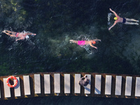 Winter swimming enthusiasts swim in the natural waters of Heilong Cave in Handan, China, on December 15, 2024. (