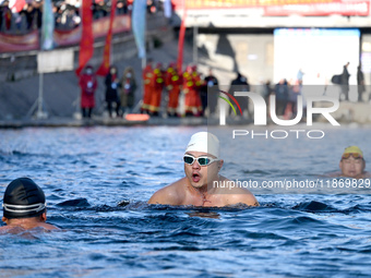 Winter swimming enthusiasts swim in the natural waters of Heilong Cave in Handan, China, on December 15, 2024. (