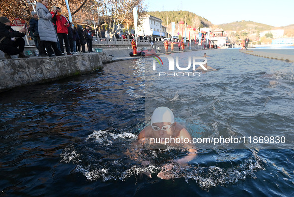 Winter swimming enthusiasts swim in the natural waters of Heilong Cave in Handan, China, on December 15, 2024. 