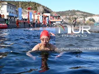 Winter swimming enthusiasts swim in the natural waters of Heilong Cave in Handan, China, on December 15, 2024. (