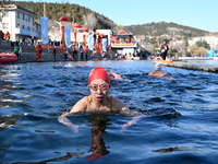 Winter swimming enthusiasts swim in the natural waters of Heilong Cave in Handan, China, on December 15, 2024. (