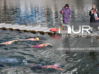 Winter swimming enthusiasts swim in the natural waters of Heilong Cave in Handan, China, on December 15, 2024. (