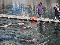 Winter swimming enthusiasts swim in the natural waters of Heilong Cave in Handan, China, on December 15, 2024. (