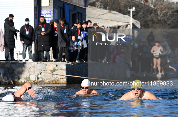 Winter swimming enthusiasts swim in the natural waters of Heilong Cave in Handan, China, on December 15, 2024. 