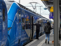 At Platform 5 of Augsburg Central Station in Bavaria, Germany, on December 14, 2024, a train attendant ensures smooth boarding for passenger...