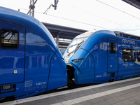 Two Arverio regional trains stand coupled at Augsburg Central Station in Bavaria, Germany, on December 14, 2024. The bright blue trains refl...