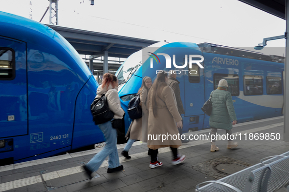 An Arverio train is stationed at Augsburg Central Station in Augsburg, Bavaria, Germany, on December 14, 2024, showcasing the vibrant blue d...