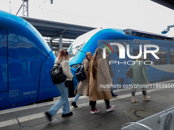 An Arverio train is stationed at Augsburg Central Station in Augsburg, Bavaria, Germany, on December 14, 2024, showcasing the vibrant blue d...